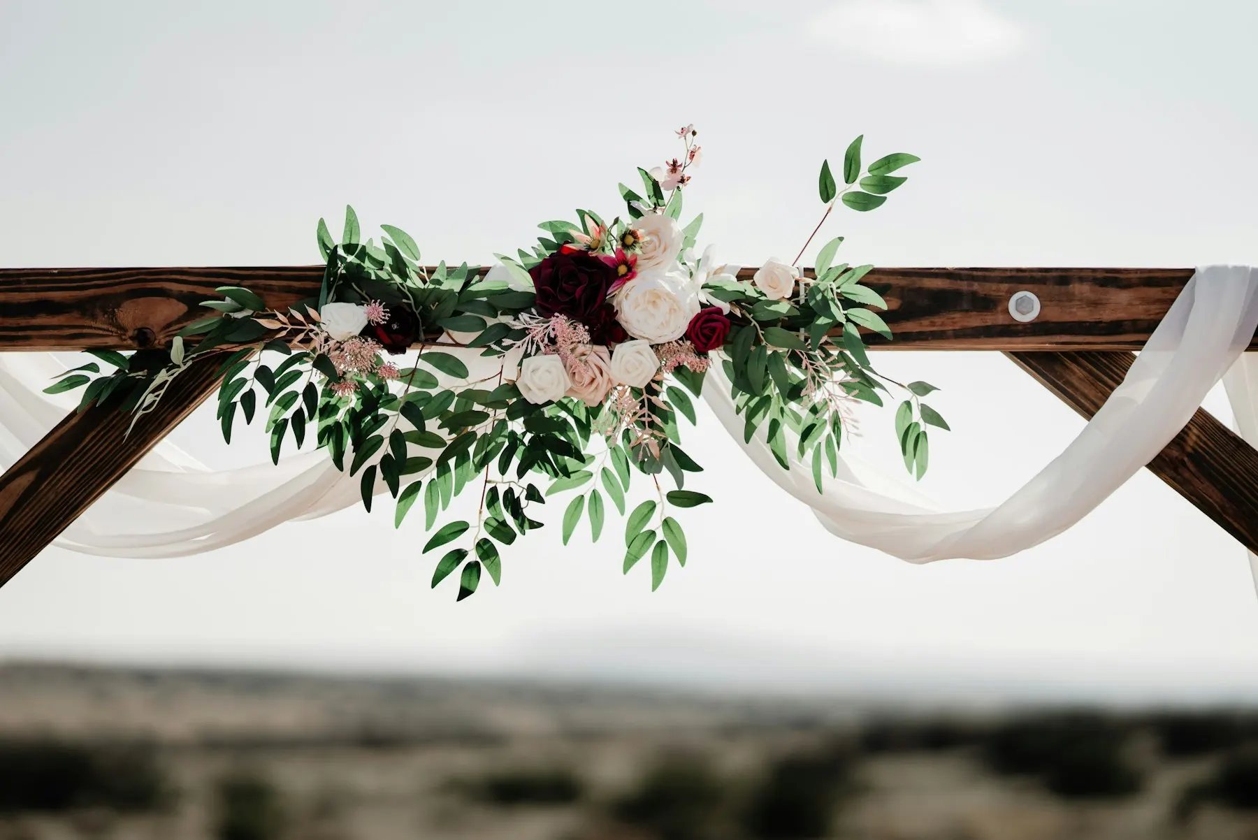 Arch decorated with flowers and greenery