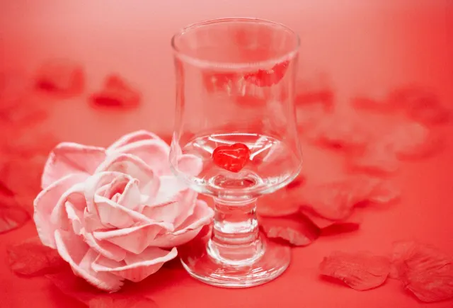 Red rose and glass with a heart